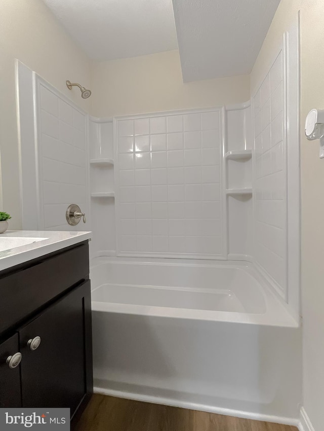 bathroom with shower / bathing tub combination, vanity, and hardwood / wood-style flooring