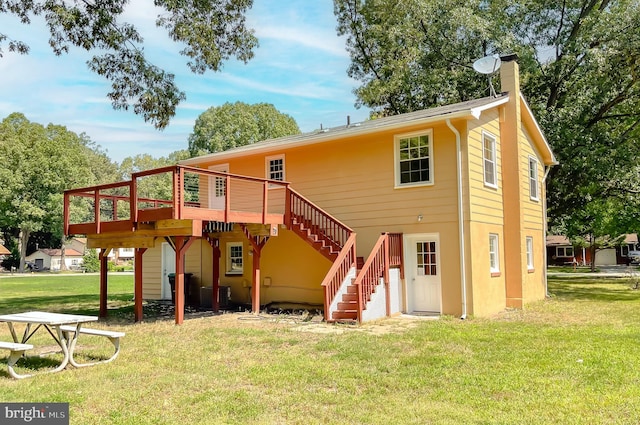 rear view of property with a yard, central AC unit, and a wooden deck