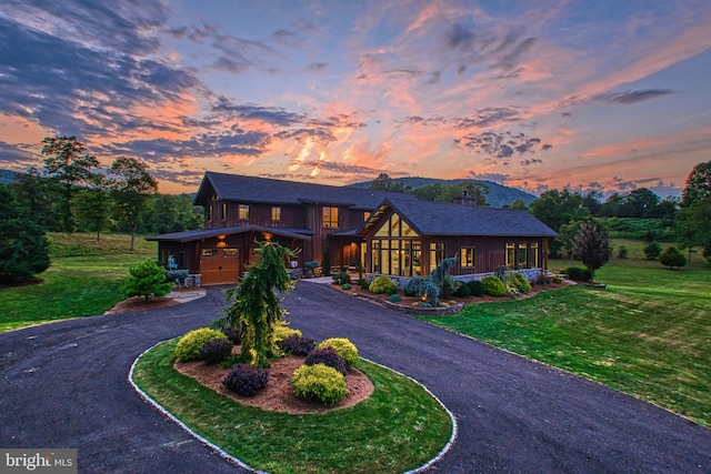 view of front facade featuring a garage and a lawn