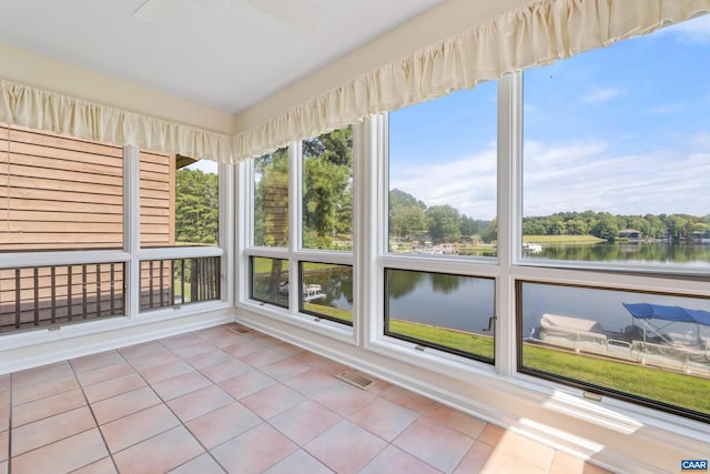 unfurnished sunroom with a water view and visible vents