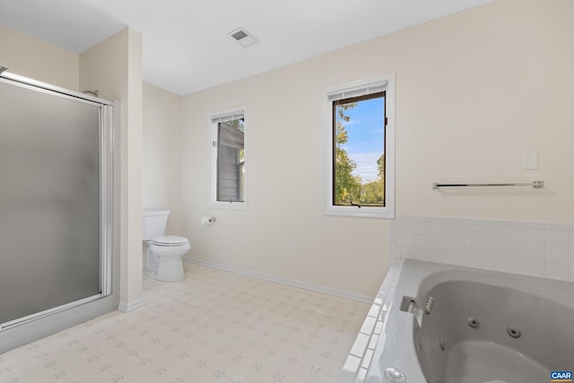 bathroom featuring tile patterned flooring, shower with separate bathtub, and toilet