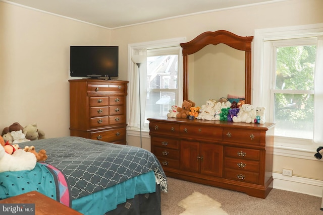 bedroom featuring light carpet and crown molding