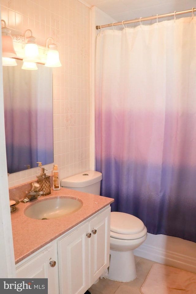 bathroom with tile patterned flooring, toilet, backsplash, and vanity