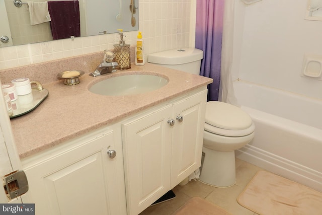 full bathroom featuring toilet, tile patterned floors, vanity, tasteful backsplash, and shower / tub combo