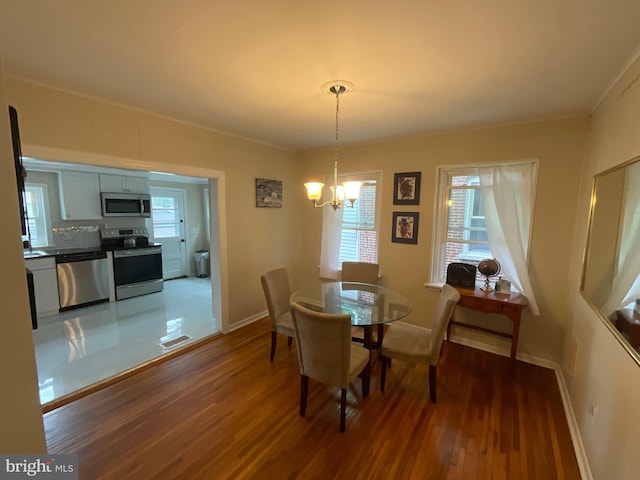 dining area featuring a chandelier and dark hardwood / wood-style floors