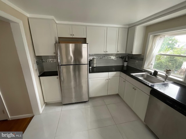 kitchen featuring tasteful backsplash, light tile patterned flooring, stainless steel appliances, and sink