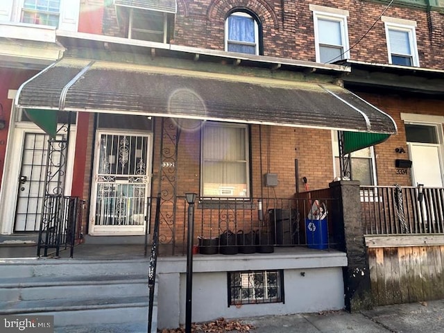 view of exterior entry with brick siding