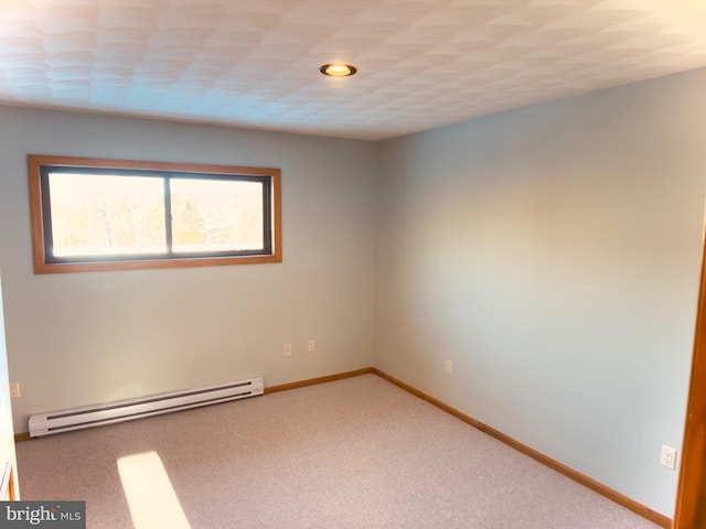 empty room featuring carpet floors and a baseboard radiator