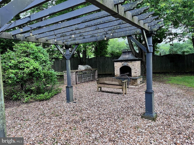 view of patio / terrace with a pergola and an outdoor stone fireplace