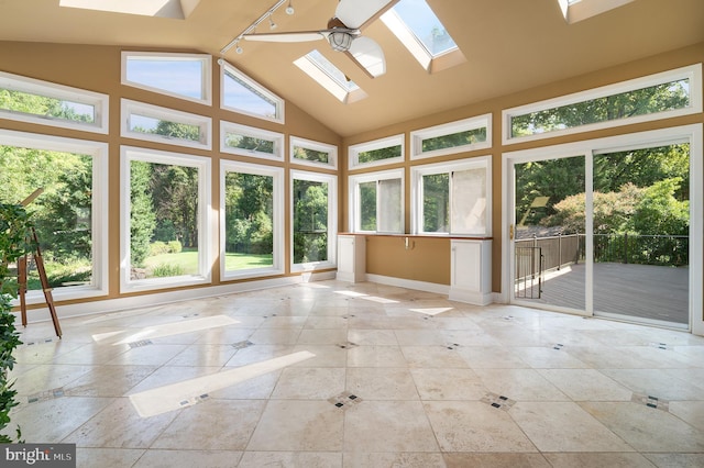 unfurnished sunroom with vaulted ceiling with skylight and ceiling fan