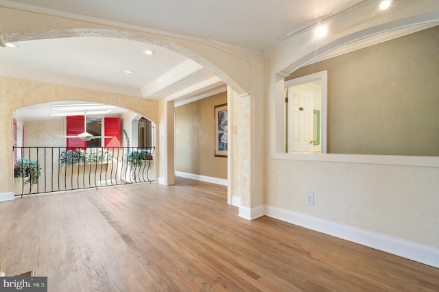 spare room with hardwood / wood-style floors and crown molding