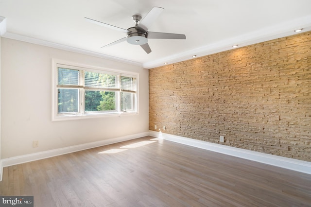 spare room with ceiling fan, hardwood / wood-style flooring, and crown molding