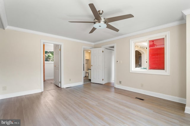 unfurnished bedroom featuring connected bathroom, ornamental molding, ceiling fan, and light hardwood / wood-style flooring