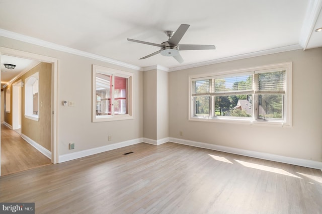 empty room with light hardwood / wood-style flooring, ceiling fan, and crown molding