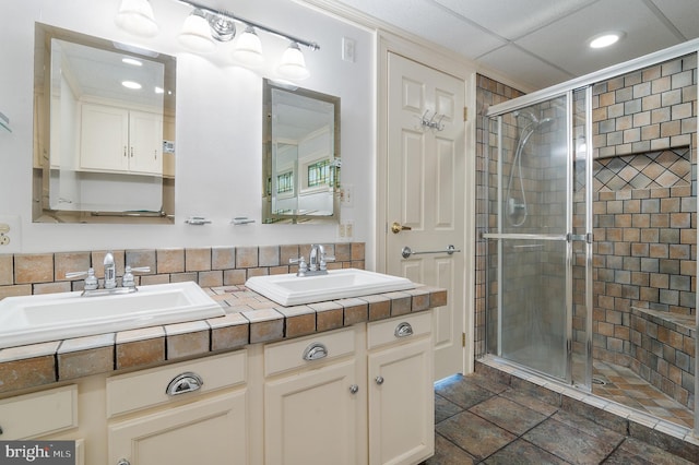 bathroom with walk in shower, vanity, and tasteful backsplash