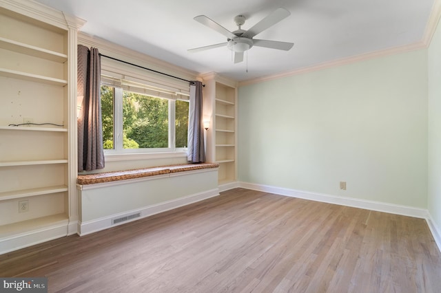 spare room with wood-type flooring, ornamental molding, and ceiling fan