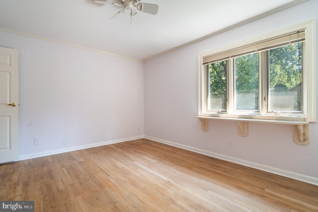 empty room featuring ornamental molding, light hardwood / wood-style floors, and ceiling fan