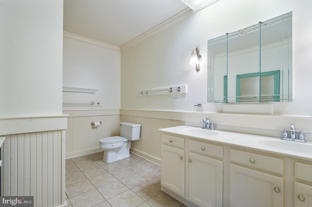 bathroom featuring ornamental molding, vanity, toilet, and tile patterned floors