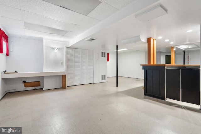 basement featuring a drop ceiling