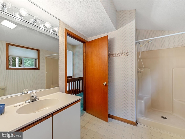 bathroom featuring vanity and a shower