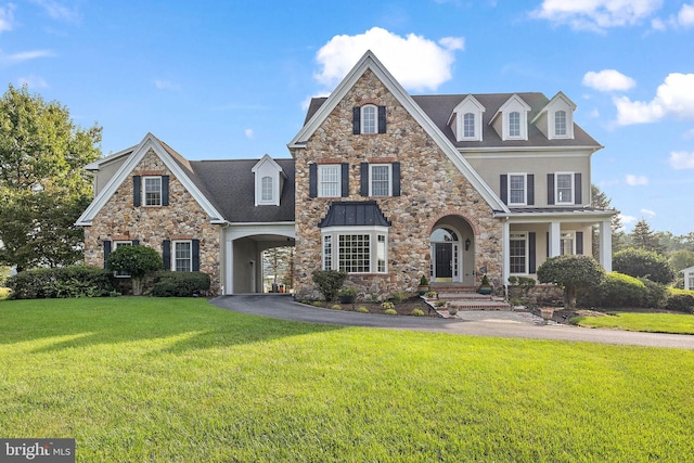 view of front of home with driveway, a front lawn, and stucco siding