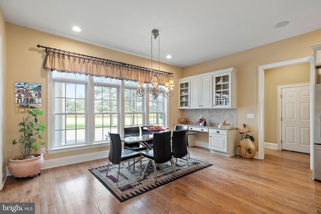 dining room with a notable chandelier and light hardwood / wood-style floors