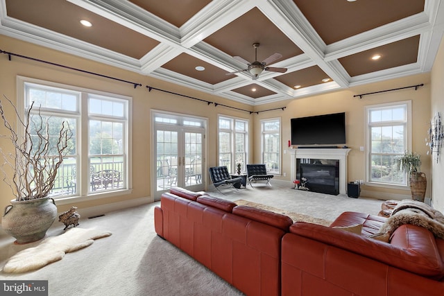 living room with coffered ceiling, beamed ceiling, carpet floors, crown molding, and ceiling fan