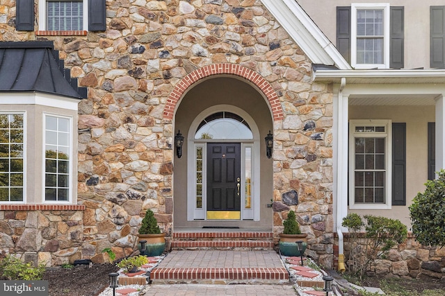 doorway to property featuring stone siding