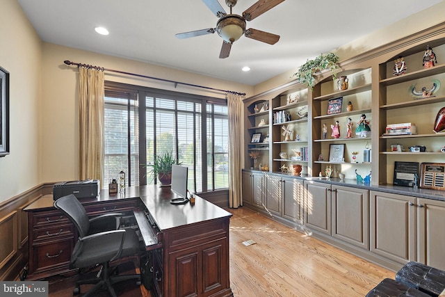 home office with ceiling fan and light hardwood / wood-style flooring