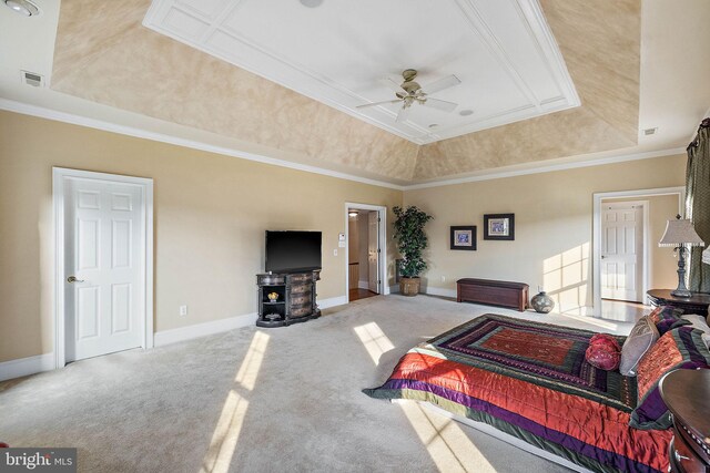 carpeted bedroom with ceiling fan, a raised ceiling, and crown molding