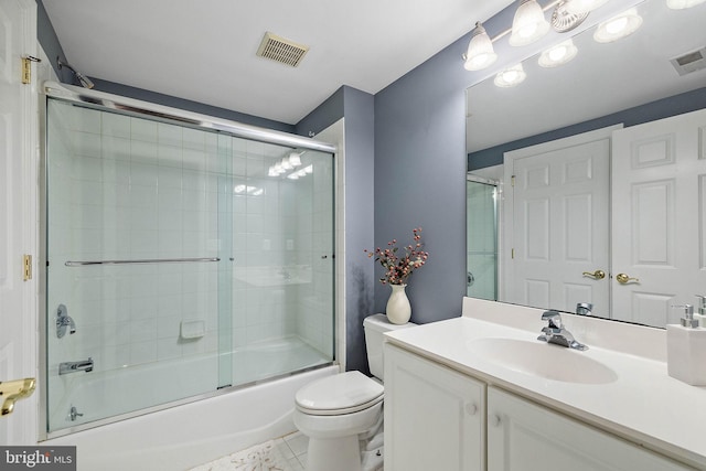 full bathroom featuring shower / bath combination with glass door, vanity, toilet, and tile patterned floors