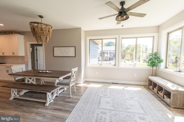 dining room featuring a healthy amount of sunlight, ceiling fan, and light hardwood / wood-style flooring