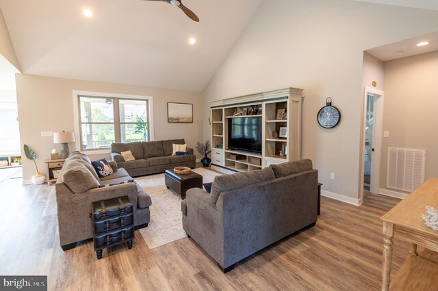 living room featuring high vaulted ceiling, wood-type flooring, and ceiling fan