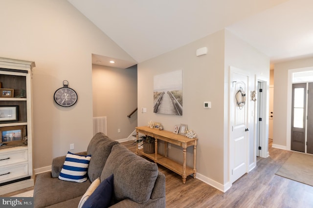 living room with lofted ceiling and light hardwood / wood-style flooring