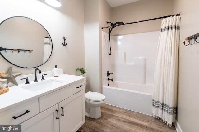 full bathroom with vanity, toilet, shower / tub combo, and hardwood / wood-style floors