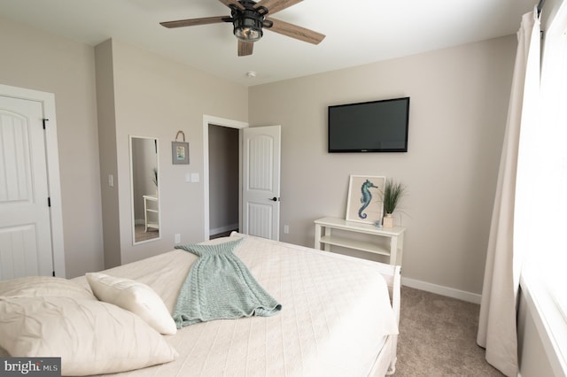 bedroom featuring light colored carpet and ceiling fan