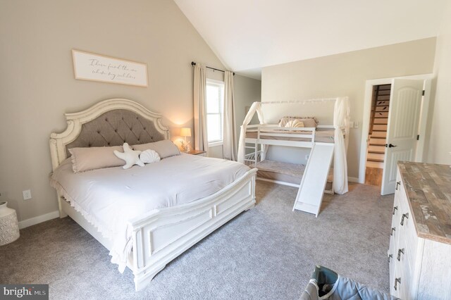 carpeted bedroom with lofted ceiling