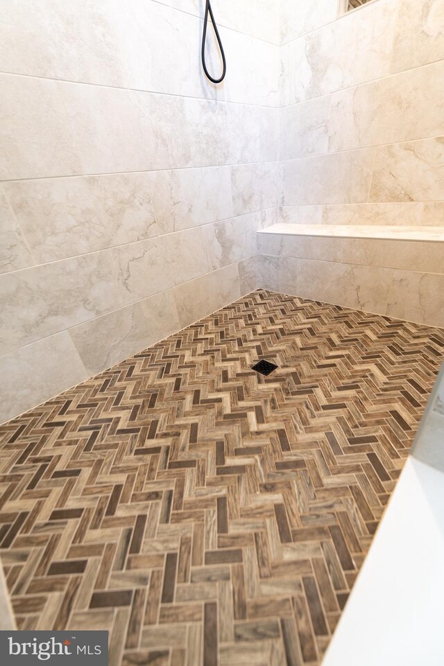 interior space featuring tiled shower and parquet flooring