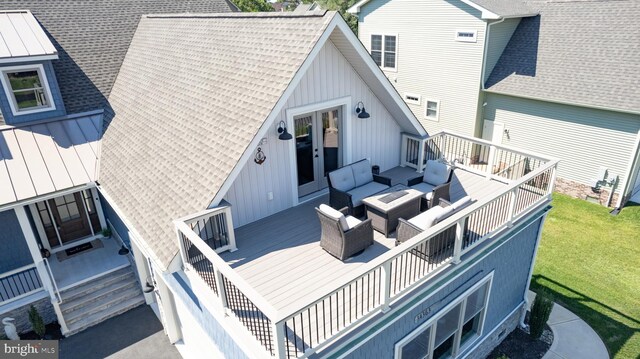 rear view of house with a yard, an outdoor living space, and a deck