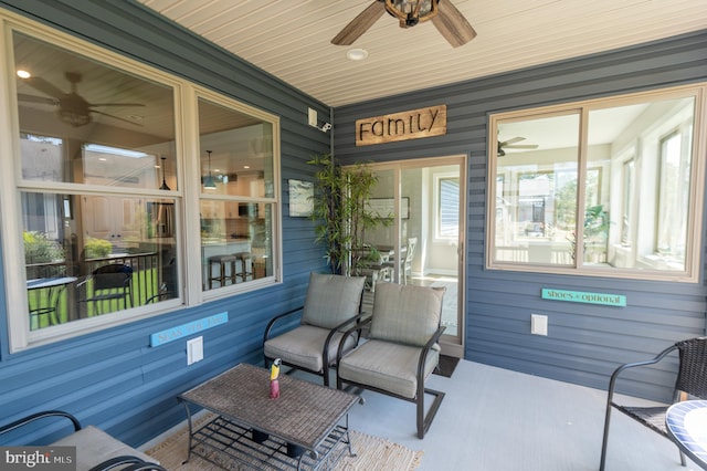 sunroom / solarium featuring wood ceiling and ceiling fan