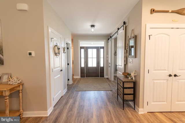 foyer featuring dark hardwood / wood-style flooring and a barn door