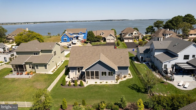 birds eye view of property with a water view