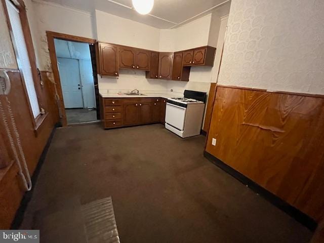 kitchen featuring white range and sink