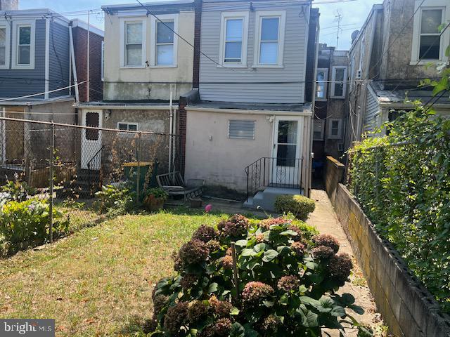 rear view of house with a lawn