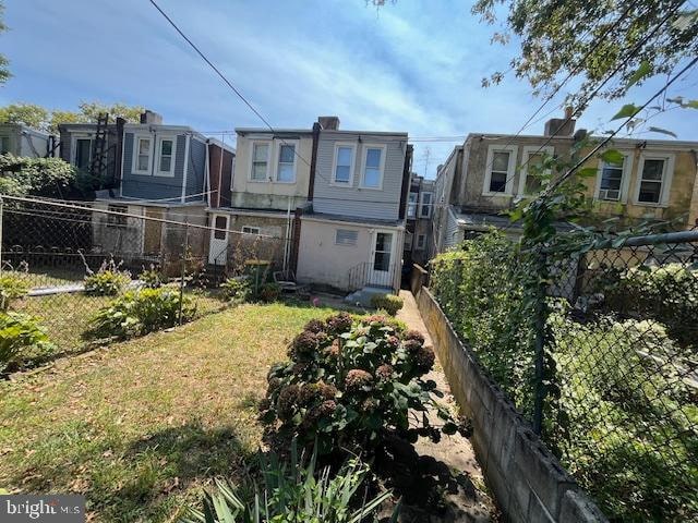 rear view of property featuring a yard