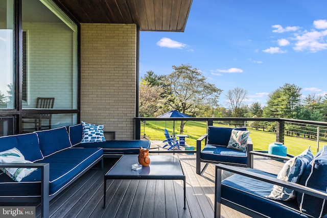 wooden terrace featuring an outdoor hangout area and a lawn