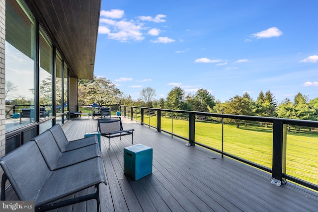 wooden terrace featuring a yard