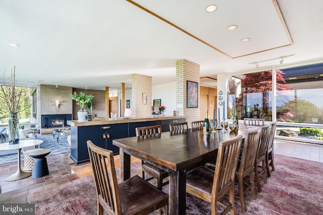 dining area with a brick fireplace