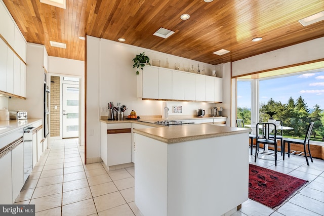 kitchen featuring white cabinets, wood ceiling, light tile patterned floors, and a center island