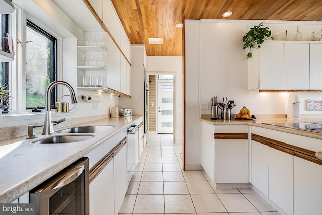 kitchen featuring white cabinets, light tile patterned floors, wooden ceiling, sink, and wine cooler